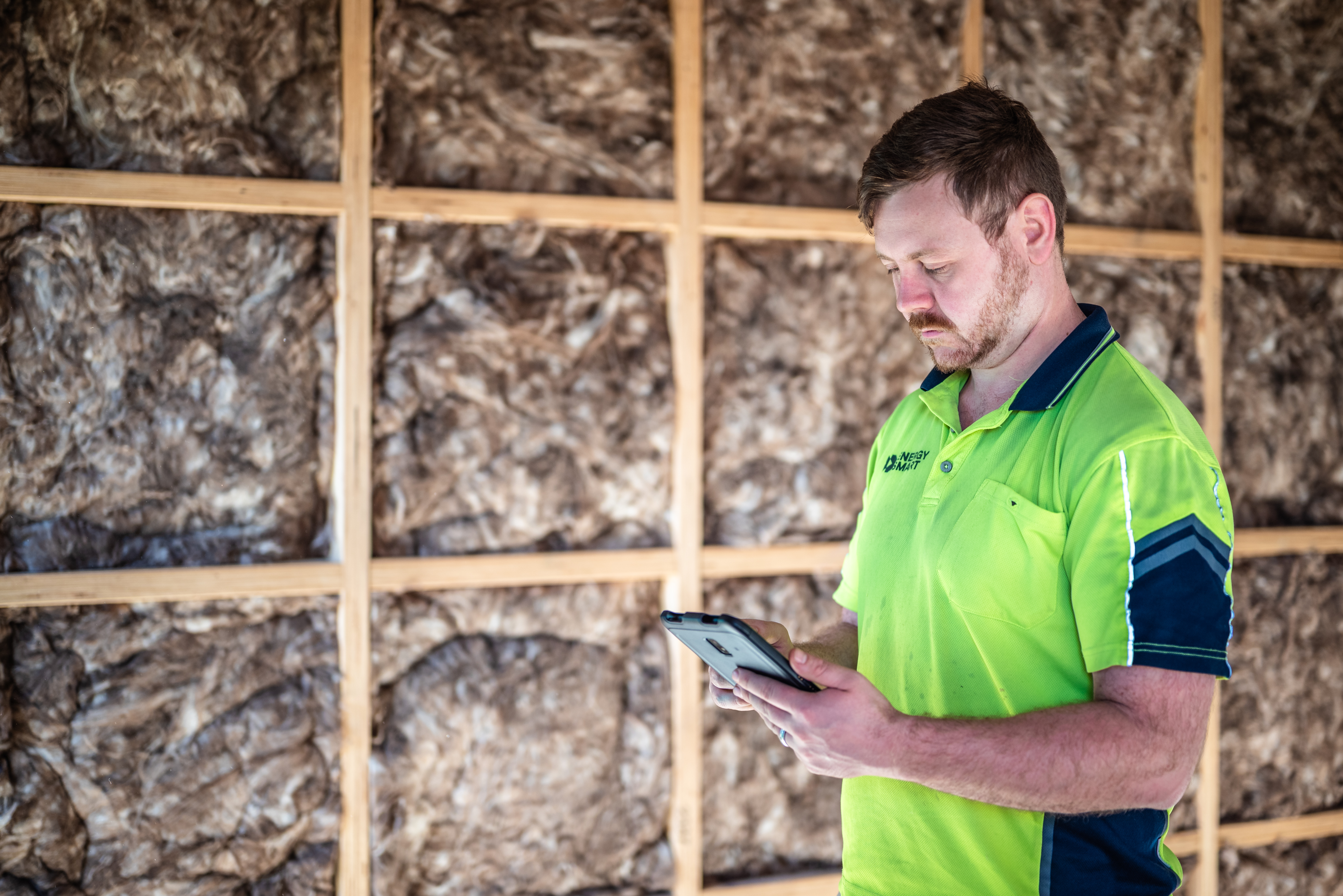 EnergySmart representative checks home insulation installation.