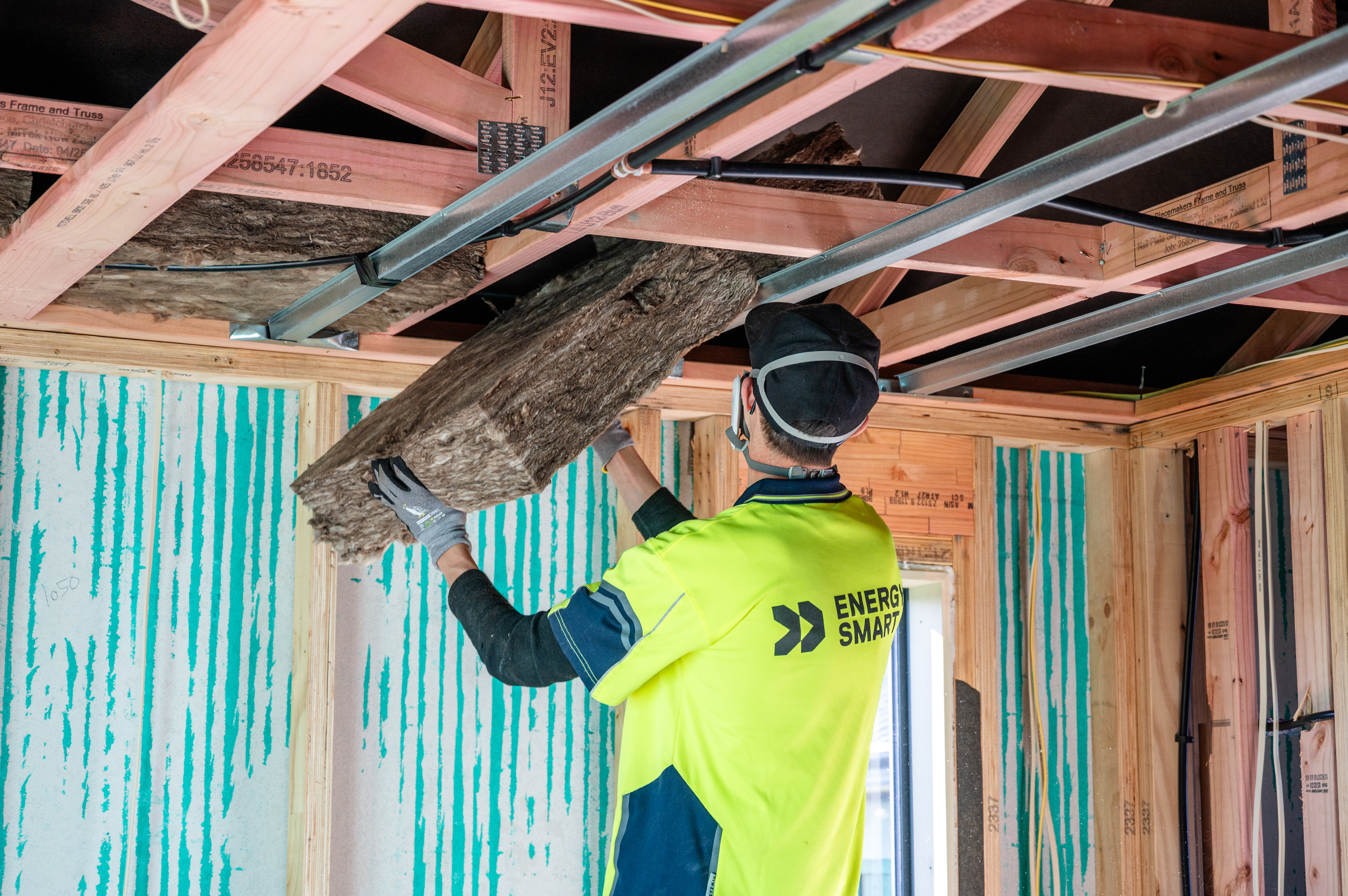 EnergySmart Insulation installer inserting insulation into ceiling