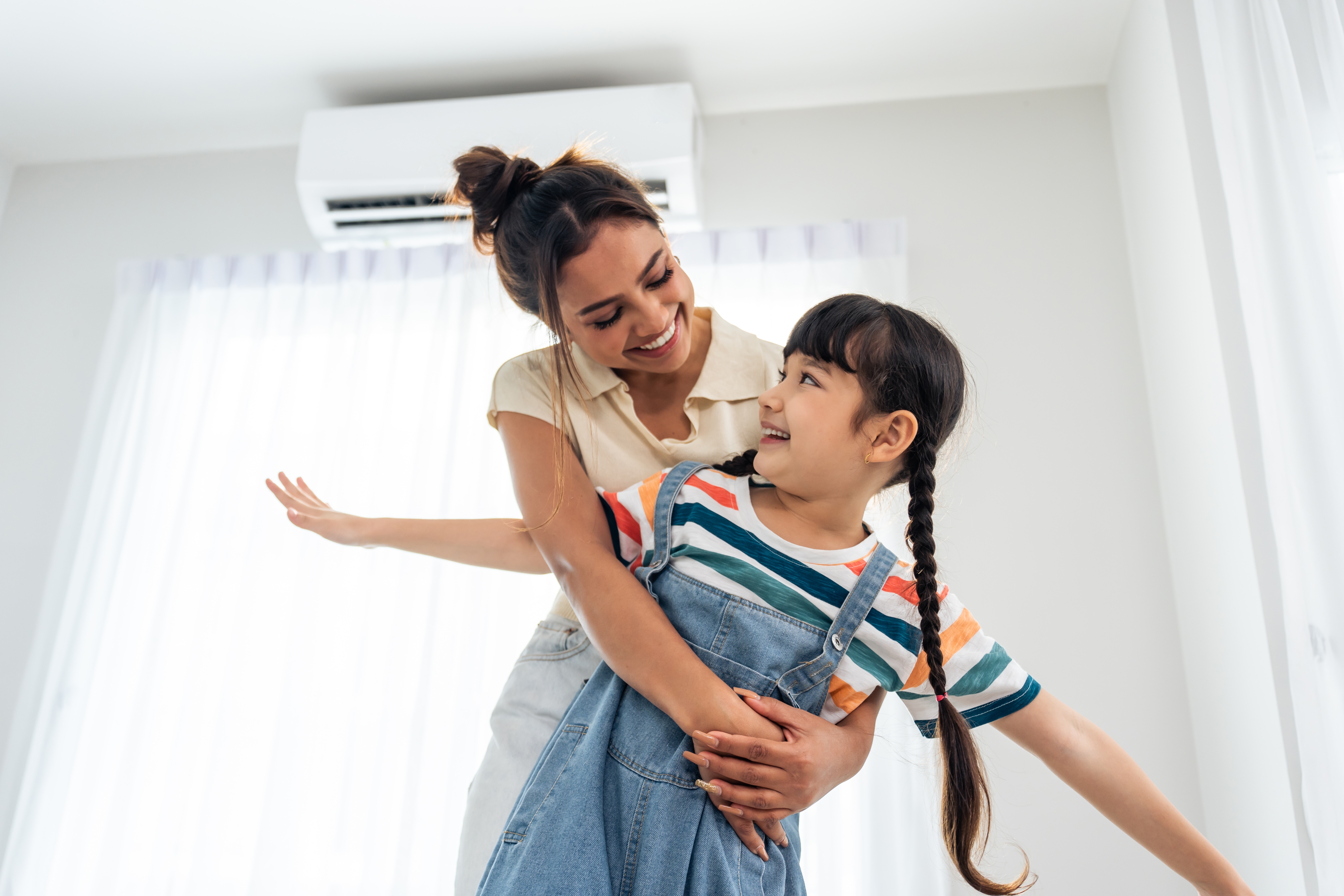 Mother and daughter enjoy new heat pump installed in family home