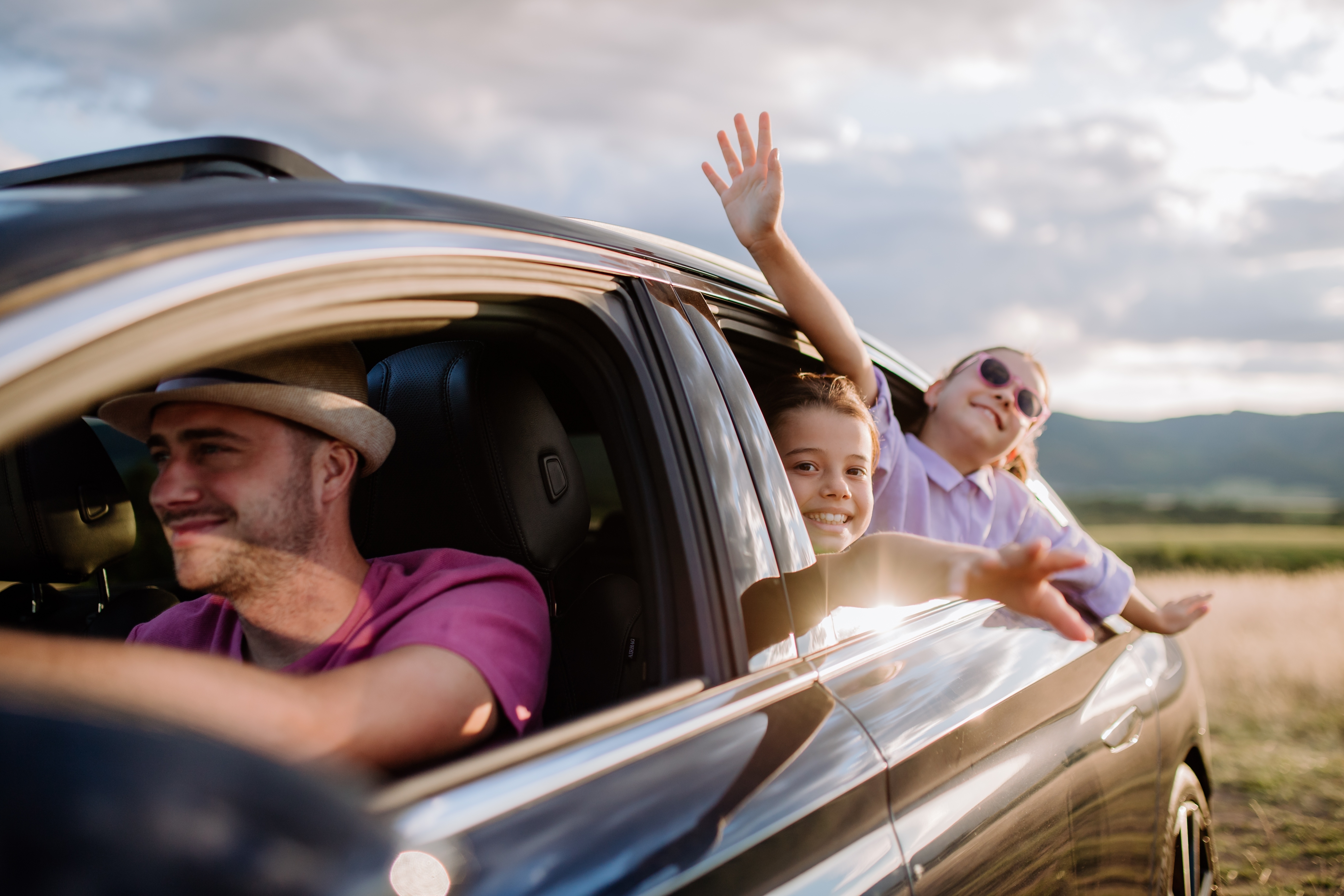 Family in car with sun shining